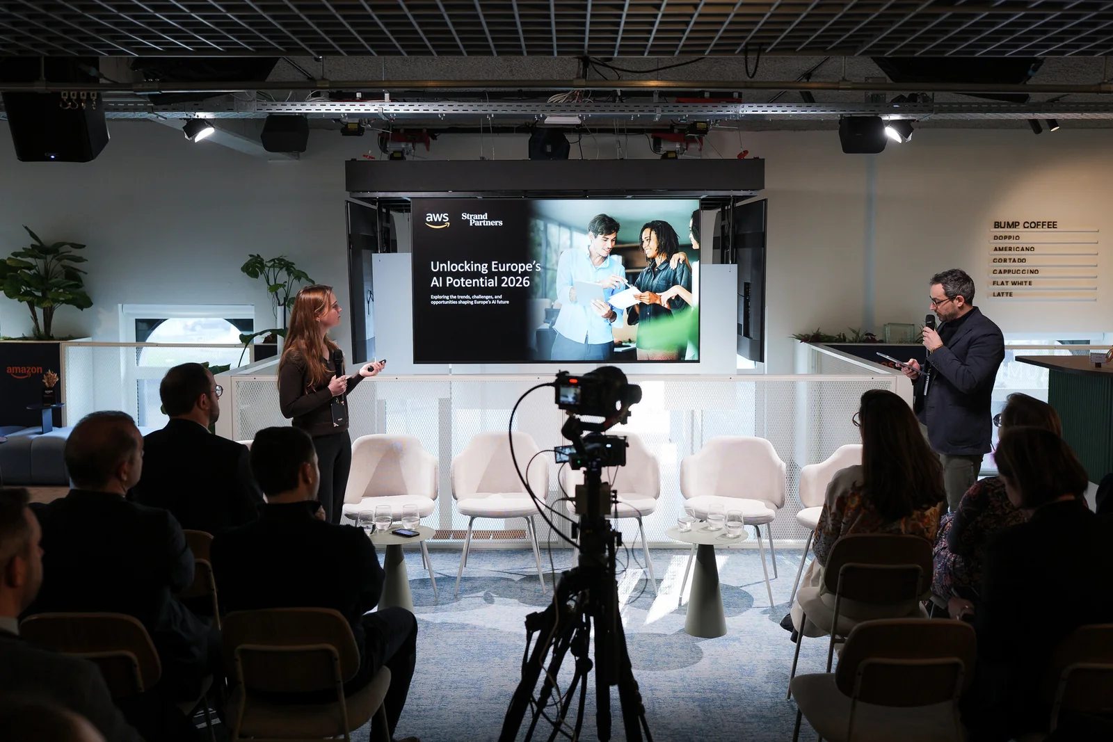 A speaker presenting to a seated audience