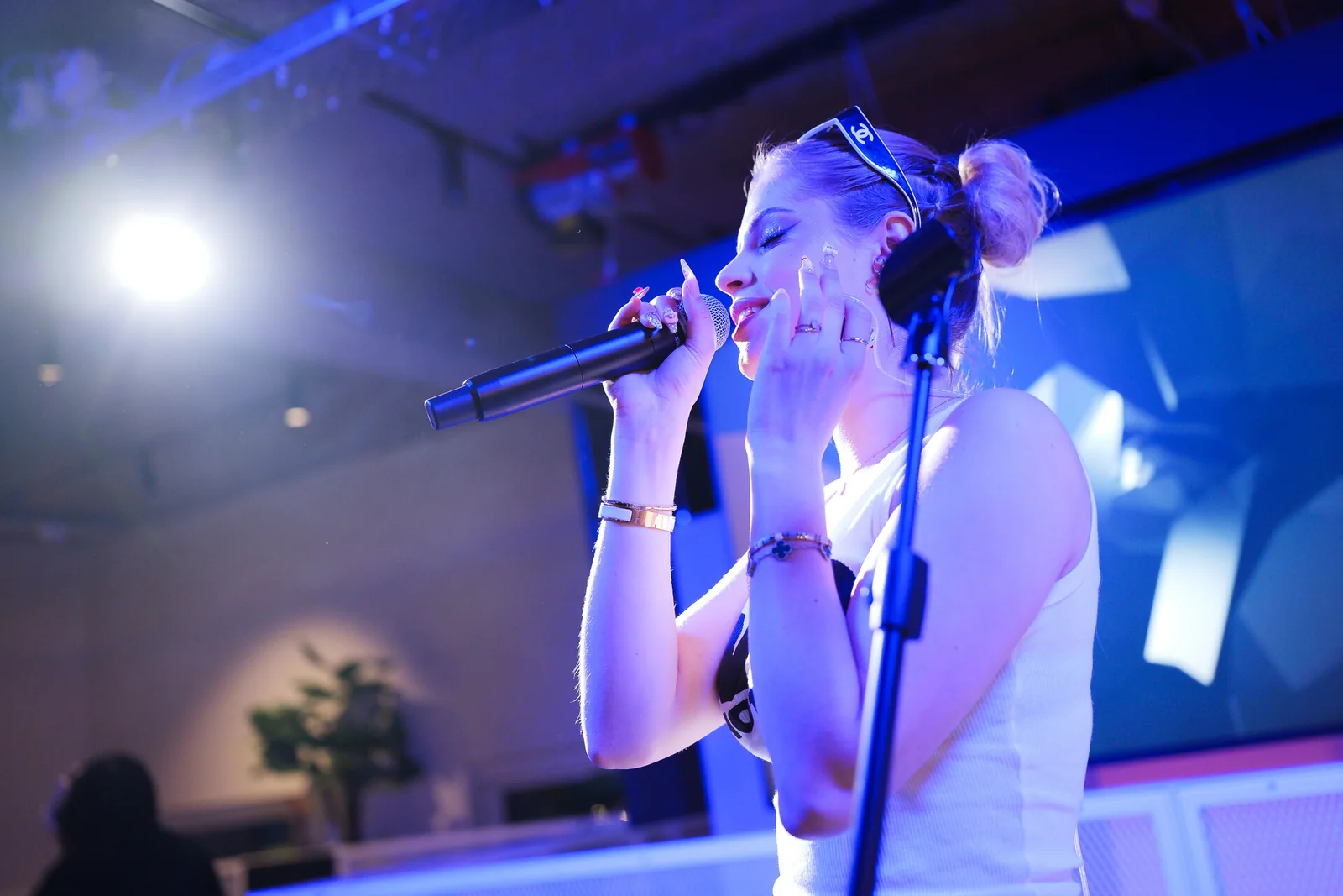 A singer performing under blue stage light